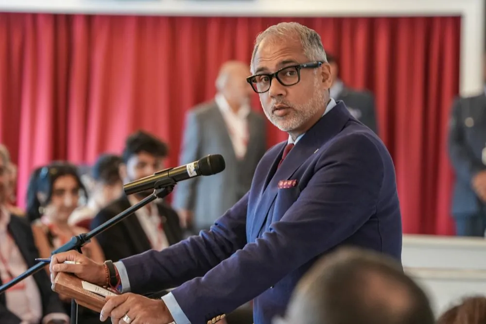 Alpesh Patel OBE speaking at a lectern