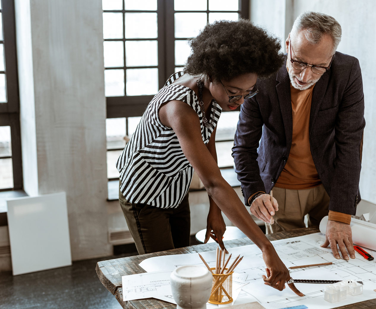 A Man and a Woman looking at a Design